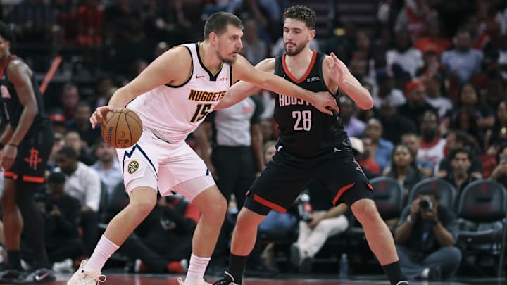Nov 21, 2025; Houston, Texas, USA; Denver Nuggets center Nikola Jokic (15) controls the ball as Houston Rockets center Alperen Sengun (28) defends during the second quarter at Toyota Center. Mandatory Credit: Troy Taormina-Imagn Images