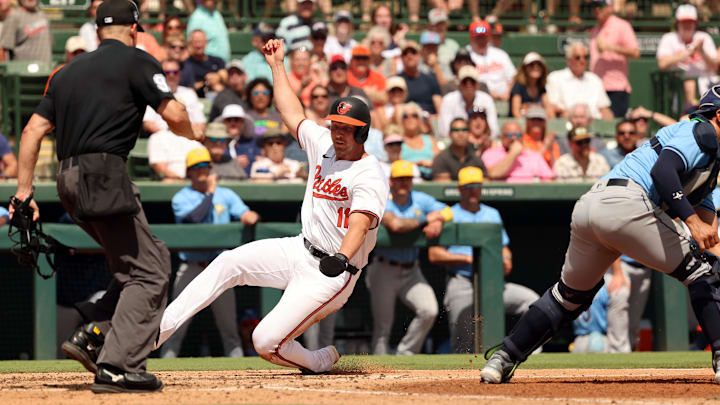 Mar 12, 2024; Sarasota, Florida, USA;  Baltimore Orioles second baseman Jordan Westburg (11) slides into home plate to score a run during the fifth inning against the Tampa Bay Rays at Ed Smith Stadium.