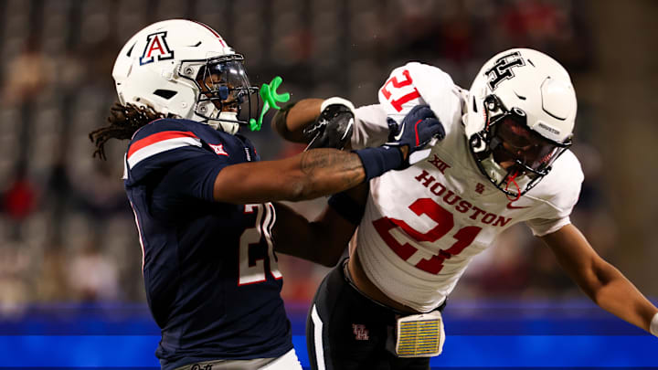 Nov 15, 2024; Tucson, Arizona, USA; Arizona Wildcats defensive back Marquis Groves-Killebrew (20) shoves Houston Cougars running back Stacy Sneed (21) during the third quarter at Arizona Stadium. Mandatory Credit: Aryanna Frank-Imagn Images