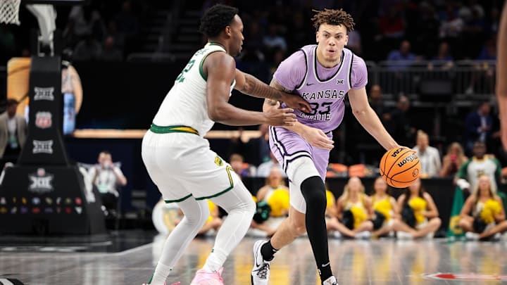 Mar 12, 2025; Kansas City, MO, USA; Kansas State Wildcats guard Coleman Hawkins (33) brings the ball up court around Baylor Bears guard Jalen Celestine (32) during the second half at T-Mobile Center. Mandatory Credit: William Purnell-Imagn Images
