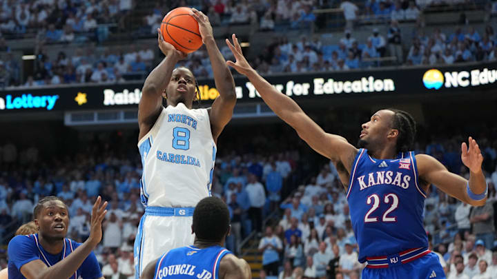 Nov 7, 2025; Chapel Hill, North Carolina, USA;  North Carolina Tar Heels forward Caleb Wilson (8) shoots as Kansas Jayhawks forward Flory Bidunga (40) and guard Melvin Council Jr. (14) and guard Darryn Peterson (22) defend in the second half at Dean E. Smith Center. Mandatory Credit: Bob Donnan-Imagn Images