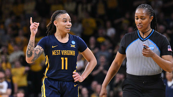 Mar 25, 2024; Iowa City, IA, USA; West Virginia Mountaineers guard JJ Quinerly (11) talks with an official during the fourth quarter against the Iowa Hawkeyes in the NCAA second round game at Carver-Hawkeye Arena. Mandatory Credit: Jeffrey Becker-Imagn Images