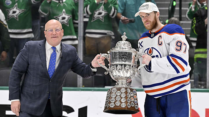 May 29, 2025; Dallas, Texas, USA; NHL deputy commissioner Bill Daly and Edmonton Oilers center Connor McDavid (97) pose with the trophy after winning the Western Conference Final of the 2025 Stanley Cup Playoffs at American Airlines Center. Mandatory Credit: Jerome Miron-Imagn Images