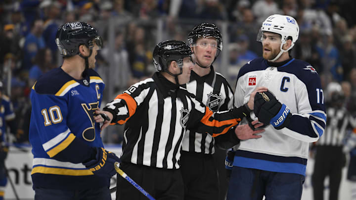 Apr 27, 2025; St. Louis, Missouri, USA; St. Louis Blues center Brayden Schenn (10) talks to Winnipeg Jets center Adam Lowry (17) during the third period in game four of the first round of the 2025 Stanley Cup Playoffs at Enterprise Center. Mandatory Credit: Jeff Le-Imagn Images