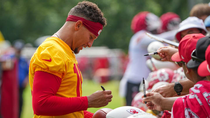 Jul 22, 2025; St. Joseph, MO, USA; Kansas City Chiefs quarterback Patrick Mahomes (15) signs autographs for fans after training camp at Missouri Western State University. Mandatory Credit: Denny Medley-Imagn Images