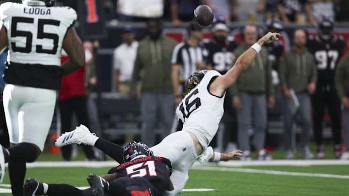 Nov 9, 2025; Houston, Texas, USA; Jacksonville Jaguars quarterback Trevor Lawrence (16) throws an interception as Houston Texans defensive end Will Anderson Jr. (51) attempts to make a tackle during the fourth quarter at NRG Stadium. Nov 9, 2025; Houston, Texas, USA; Jacksonville Jaguars quarterback Trevor Lawrence (16) throws an interception as Houston Texans defensive end Will Anderson Jr. (51) attempts to make a tackle during the fourth quarter at NRG Stadium.