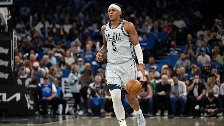 Mar 27, 2025; Orlando, Florida, USA; Orlando Magic forward Paolo Banchero (5) dribbles the ball against the Dallas Mavericks in the third quarter at Kia Center. Mandatory Credit: Jeremy Reper-Imagn Images