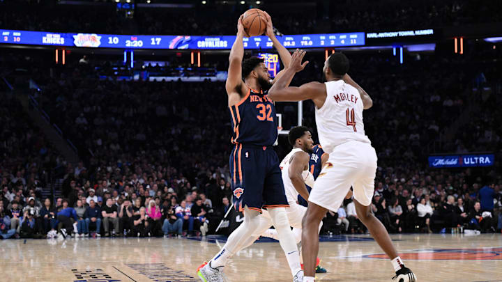 Oct 28, 2024; New York, New York, USA; New York Knicks center Karl-Anthony Towns (32) looks to pass the ball as Cleveland Cavaliers forward Evan Mobley (4) defends during the first half at Madison Square Garden. Mandatory Credit: John Jones-Imagn Images
