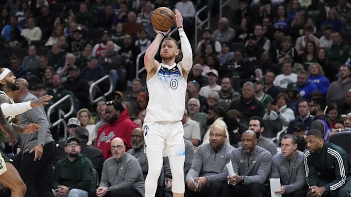 Apr 8, 2025; Milwaukee, Wisconsin, USA; Minnesota Timberwolves guard Donte DiVincenzo (0) puts up a shot in the first half against the Milwaukee Bucks at Fiserv Forum. Mandatory Credit: Michael McLoone-Imagn Images