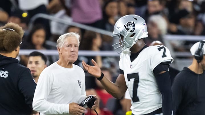 Aug 23, 2025; Glendale, Arizona, USA; Las Vegas Raiders quarterback Geno Smith (7) talks to head coach Pete Carroll against the Arizona Cardinals during a preseason NFL game at State Farm Stadium. Mandatory Credit: Mark J. Rebilas-Imagn Images