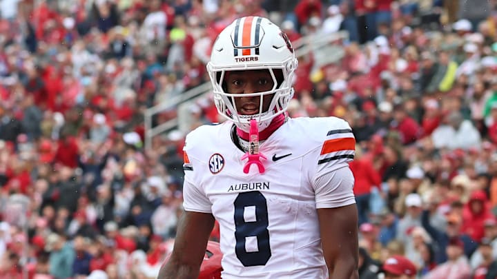 Auburn Tigers wide receiver Cam Coleman celebrates after scoring a touchdown defended by Arkansas Razorbacks defensive back Julian Neal during the first quarter at Donald W. Reynolds Razorback Stadium. 