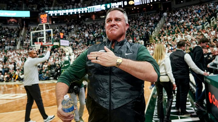 Michigan State's new football coach Pat Fitzgerald pats his heart at the crowd in attendance for the Spartans basketball game against Iowa on Tuesday, Dec. 2, 2025, at the Breslin Center in East Lansing. Michigan State's new football coach Pat Fitzgerald pats his heart at the crowd in attendance for the Spartans basketball game against Iowa on Tuesday, Dec. 2, 2025, at the Breslin Center in East Lansing.