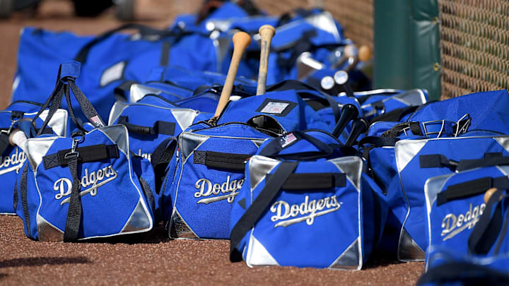 Feb 21, 2020; Glendale, Arizona, USA;  Los Angeles Dodgers bags line up along a fence during spring training at Camelback Ranch. Mandatory Credit: Jayne Kamin-Oncea-Imagn Images