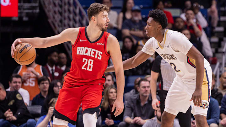 Dec 18, 2025; New Orleans, Louisiana, USA;  Houston Rockets center Alperen Sengun (28) dribbles against New Orleans Pelicans center Derik Queen (22) during the first half at Smoothie King Center. Mandatory Credit: Stephen Lew-Imagn Images