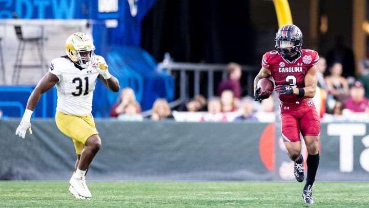 Dec 30, 2022; Jacksonville, FL, USA; Notre Dame Fighting Irish defensive lineman Nana Osafo-Mensah (31) chases South Carolina Gamecocks wide receiver Antwane Wells Jr. (3) during the first half in the 2022 Gator Bowl at TIAA Bank Field. Mandatory Credit: Matt Pendleton-USA TODAY Sports Dec 30, 2022; Jacksonville, FL, USA; Notre Dame Fighting Irish defensive lineman Nana Osafo-Mensah (31) chases South Carolina Gamecocks wide receiver Antwane Wells Jr. (3) during the first half in the 2022 Gator Bowl at TIAA Bank Field. Mandatory Credit: Matt Pendleton-USA TODAY Sports