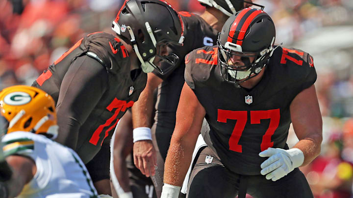 Cleveland Browns guard Wyatt Teller (77) has a word with offensive tackle KT Leveston (72) before a play during the first half of an NFL football game at Huntington Bank Field, Sept. 21, 2025, in Cleveland, Ohio.