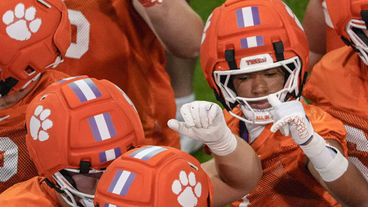 Clemson wide receiver T.J. Moore (1) joins in the huddle during Clemson football 2025 practice at the Allen N. Reeves Football Complex in Clemson, S.C. Friday, August 1, 2025.