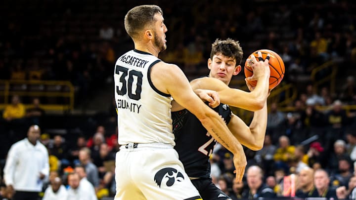 Iowa guard Connor McCaffery, left, defends Omaha forward Frankie Fidler during a NCAA men's