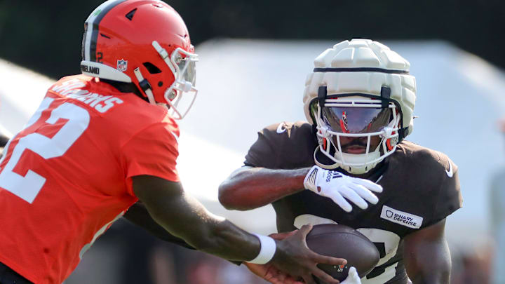 Cleveland Browns running back Dylan Sampson, right, takes a handoff from quarterback Shedeur Sanders during training camp July 30, 2025, in Berea.