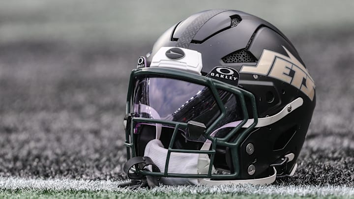 Dec 7, 2025; East Rutherford, New Jersey, USA; A general view of a Gotham City football rivalries helmet resting on the field before the game against the Miami Dolphins at MetLife Stadium. Mandatory Credit: Vincent Carchietta-Imagn Images Dec 7, 2025; East Rutherford, New Jersey, USA; A general view of a Gotham City football rivalries helmet resting on the field before the game against the Miami Dolphins at MetLife Stadium. Mandatory Credit: Vincent Carchietta-Imagn Images