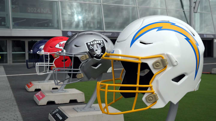Oct 13, 2024; London, United Kingdom; Large helmets of the Los Angeles Chargers, Las Vegas Raiders, Kansas City Chiefs and Denver Broncos of the AFC West before an NFL International Series game at Tottenham Hotspur Stadium. Mandatory Credit: Kirby Lee-Imagn Images