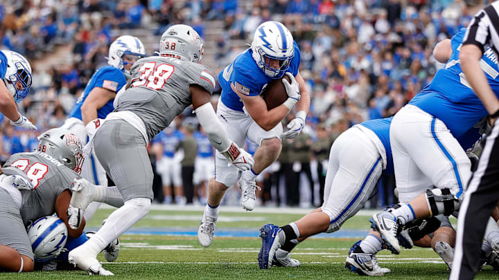Air Force Falcons running back Dylan Carson (20) runs the ball as UNLV Rebels linebacker Marsel McDuffie (38) defends in the first quarter at Falcon Stadium. 