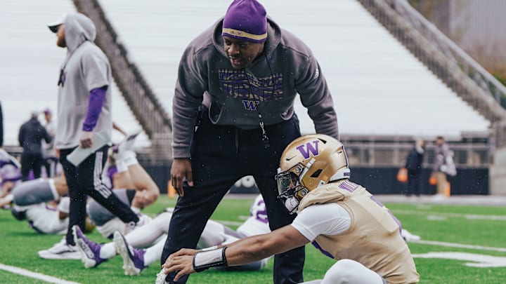 John Richardson chats up quarterback Demond Williams Jr. during stretching. John Richardson chats up quarterback Demond Williams Jr. during stretching.