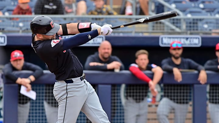 Feb 26, 2024; Peoria, Arizona, USA;  Cleveland Guardians right fielder Chase DeLauter (6) hits a two run home run in the second inning against the San Diego Padres during a spring training game at Peoria Sports Complex. Mandatory Credit: Matt Kartozian-Imagn Images