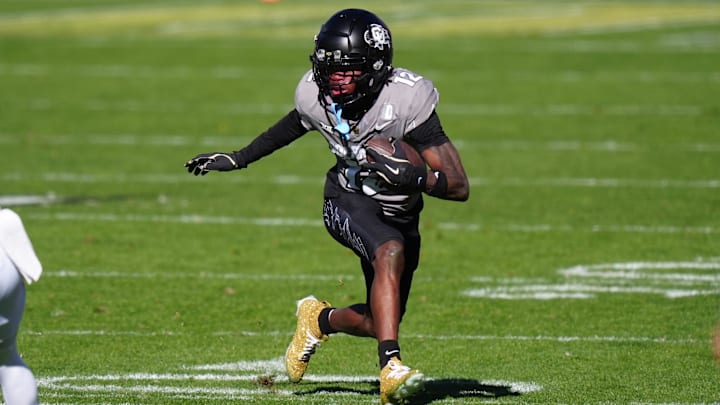 Nov 16, 2024; Boulder, Colorado, USA; Colorado Buffaloes wide receiver Travis Hunter (12) carries the ball in the second quarter against the Utah Utes at Folsom Field. Mandatory Credit: Ron Chenoy-Imagn Images