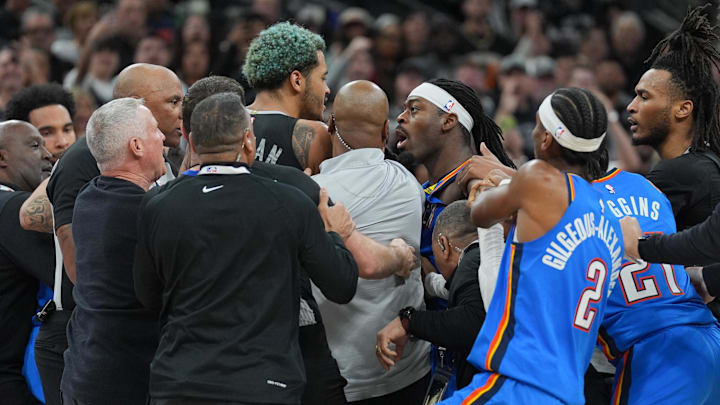 Mar 2, 2025; San Antonio, Texas, USA;  San Antonio Spurs forward Jeremy Sochan (10) and Oklahoma City Thunder guard Luguentz Dort (5) in the middle of an altercation during the second half at Frost Bank Center. Mandatory Credit: Daniel Dunn-Imagn Images