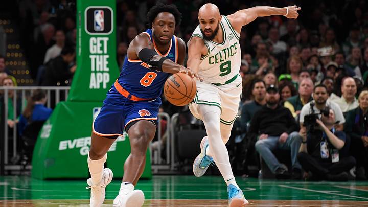 Apr 11, 2024; Boston, Massachusetts, USA;  Boston Celtics guard Derrick White (9) tries to steal the ball from New York Knicks forward OG Anunoby (8) during the first half at TD Garden. Mandatory Credit: Bob DeChiara-USA TODAY Sports