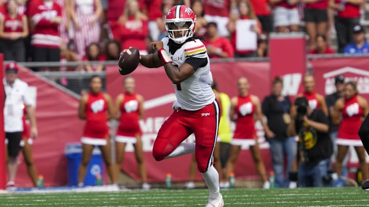 Sep 20, 2025; Madison, Wisconsin, USA;  Maryland Terrapins' Malik Washington (7) scrambles with the football during the second quarter against the Wisconsin Badgers at Camp Randall Stadium. Mandatory Credit: Jeff Hanisch-Imagn Images