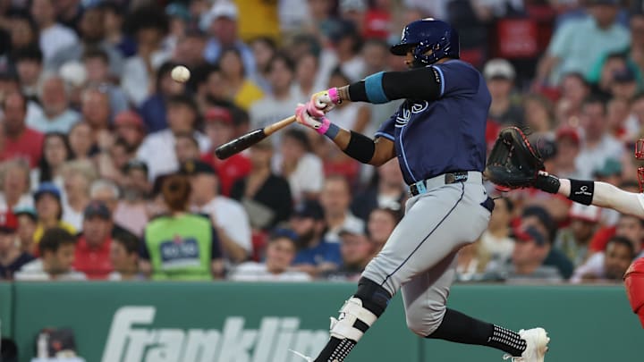 Boston, Massachusetts, USA; Tampa Bay Rays designated hitter Yandy Diaz (2) hits a two run home run during the fifth inning against the Boston Red Sox at Fenway Park.