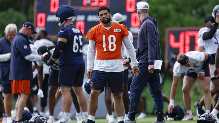 Bears quarterback Caleb Williams walks on the field during minicamp at Halas Hall for stretching. Bears quarterback Caleb Williams walks on the field during minicamp at Halas Hall for stretching.