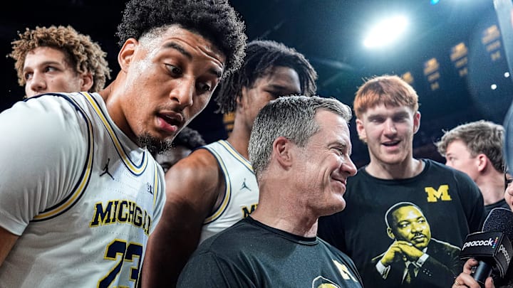 Michigan players surround head coach Dusty May’s post game interview after 86-72 win over Indiana at Crisler Center in Ann Arbor on Tuesday, Jan. 20, 2026.