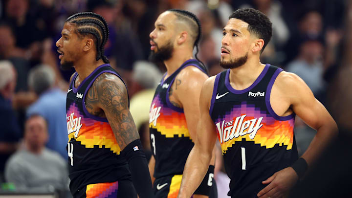 Apr 7, 2026; Phoenix, Arizona, USA; Phoenix Suns guard Jalen Green (4), forward Dillon Brooks (3) and guard Devin Booker (1) against the Houston Rockets at Mortgage Matchup Center. Mandatory Credit: Mark J. Rebilas-Imagn Images

