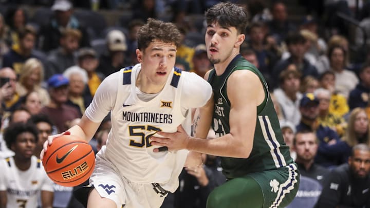 Nov 30, 2025; Morgantown, West Virginia, USA; West Virginia Mountaineers guard Treysen Eaglestaff (52) drives baseline past Mercyhurst Lakers guard Or Faran Frenkel (23) during the second half at Hope Coliseum. Mandatory Credit: Ben Queen-Imagn Images Nov 30, 2025; Morgantown, West Virginia, USA; West Virginia Mountaineers guard Treysen Eaglestaff (52) drives baseline past Mercyhurst Lakers guard Or Faran Frenkel (23) during the second half at Hope Coliseum. Mandatory Credit: Ben Queen-Imagn Images
