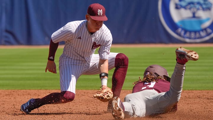 Mississippi State shortstop Sawyer Reeves (2) takes a throw at second too late to catch Texas A&M right fielder Terrence Kiel II (3) who steals second in the first round of the SEC Baseball Tournament at the Hoover Met.
