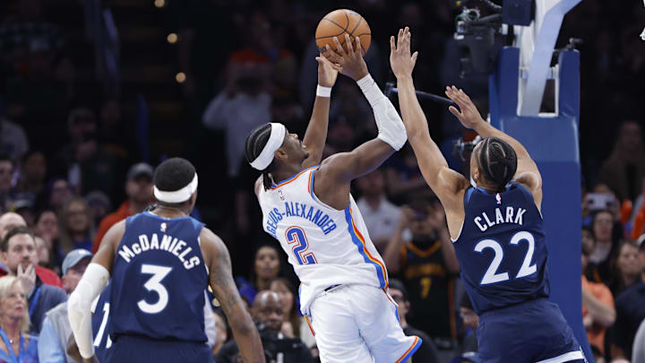 Feb 24, 2025; Oklahoma City, Oklahoma, USA; Oklahoma City Thunder guard Shai Gilgeous-Alexander (2) shoots as Minnesota Timberwolves guard Jaylen Clark (22) defends during the second half at Paycom Center.