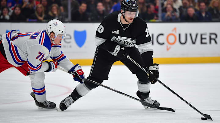 Mar 25, 2025; Los Angeles, California, USA; Los Angeles Kings left wing Tanner Jeannot (10) moves the puck against New York Rangers center Juuso Parssinen (71) during the second period at Crypto.com Arena. Mandatory Credit: Gary A. Vasquez-Imagn Images