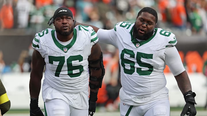 Oct 26, 2025; Cincinnati, Ohio, USA; New York Jets guard John Simpson (76) and guard Xavier Newman (65) walks off the court after winning the game against the Cincinnati Bengals at Paycor Stadium. Mandatory Credit: Joseph Maiorana-Imagn Images