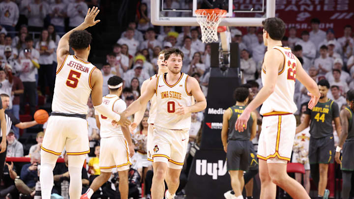 Feb 7, 2026; Ames, Iowa, USA; Iowa State Cyclones forward Joshua Jefferson (5) and Iowa State Cyclones forward Milan Momcilovic (22) wait to celebrate with Iowa State Cyclones guard Nate Heise (0) after the basket in their game with the Baylor Bears during the second half at James H. Hilton Coliseum. 