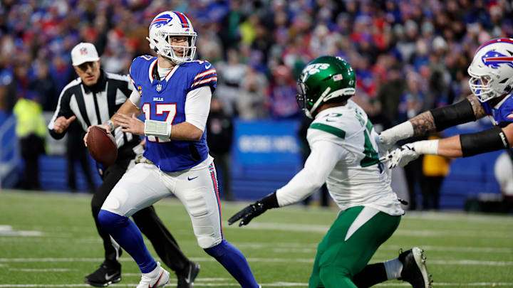 Buffalo Bills quarterback Josh Allen (17) rolls away from pressure against the Jets.