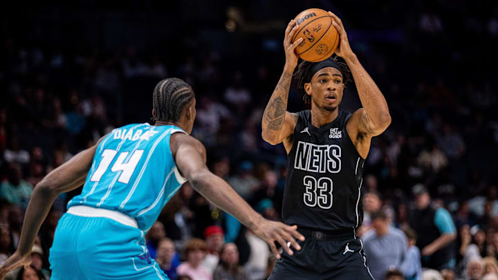 Mar 8, 2025; Charlotte, North Carolina, USA; Brooklyn Nets center Nic Claxton (33) is guarded by Charlotte Hornets forward Moussa Diabate (14) during the first quarter at Spectrum Center. Mandatory Credit: Scott Kinser-Imagn Images