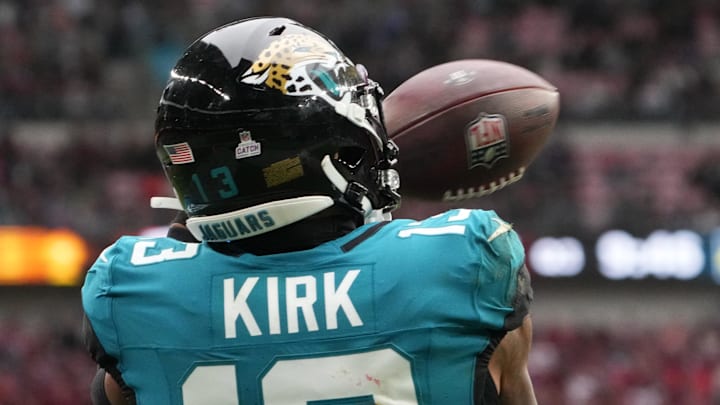 Oct 20, 2024; London, United Kingdom; Jacksonville Jaguars wide receiver Christian Kirk (13) attempts to catch the ball against New England Patriots cornerback Marcus Jones (25) in the second half of an NFL International Series game at Wembley Stadium. Mandatory Credit: Kirby Lee-Imagn Images