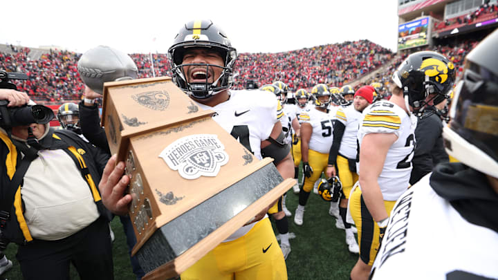 Nov 24, 2023; Lincoln, Nebraska, USA; Iowa Hawkeyes defensive lineman Yahya Black (94) carries the Heroes Trophy after beating the Nebraska Cornhuskers at Memorial Stadium. Mandatory Credit: Reese Strickland-Imagn Images Nov 24, 2023; Lincoln, Nebraska, USA; Iowa Hawkeyes defensive lineman Yahya Black (94) carries the Heroes Trophy after beating the Nebraska Cornhuskers at Memorial Stadium. Mandatory Credit: Reese Strickland-Imagn Images
