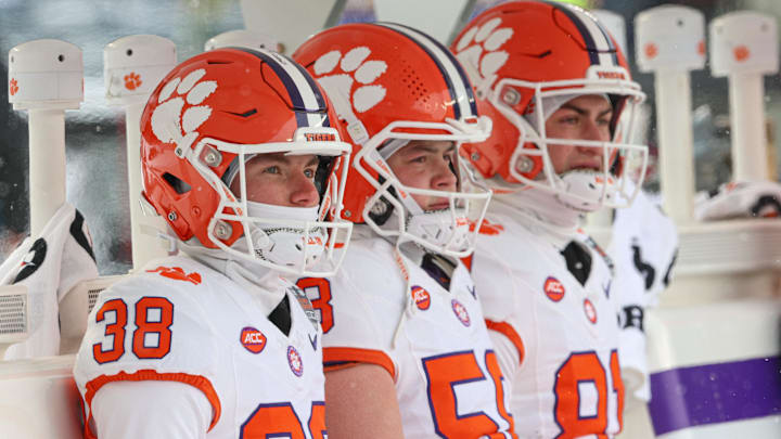 Dec 27, 2025; Bronx, NY, USA; Clemson Tigers kicker Robert Gunn III (38), long snapper Holden Caspersen (58) and kicker Nolan Hauser (81) sit on heated seats before the 2025 Pinstripe Bowl against the Penn State Nittany Lions at Yankee Stadium. Mandatory Credit: Vincent Carchietta-Imagn Images