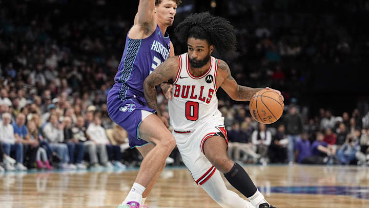 Dec 12, 2025; Charlotte, North Carolina, USA; Chicago Bulls guard Coby White (0) drives to the basket against Charlotte Hornets forward Tidjane Salaun (31) during the second half at Spectrum Center. Mandatory Credit: Jim Dedmon-Imagn Images