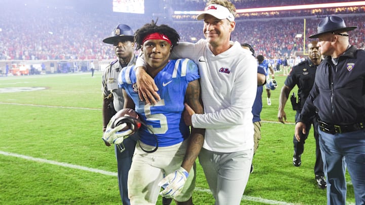 Nov 15, 2025; Oxford, Mississippi, USA; Mississippi Rebels head coach Lane Kiffin embraces running back Kewan Lacy (5) after defeating the Florida Gators at Vaught-Hemingway Stadium. Mandatory Credit: Petre Thomas-Imagn Images Nov 15, 2025; Oxford, Mississippi, USA; Mississippi Rebels head coach Lane Kiffin embraces running back Kewan Lacy (5) after defeating the Florida Gators at Vaught-Hemingway Stadium. Mandatory Credit: Petre Thomas-Imagn Images