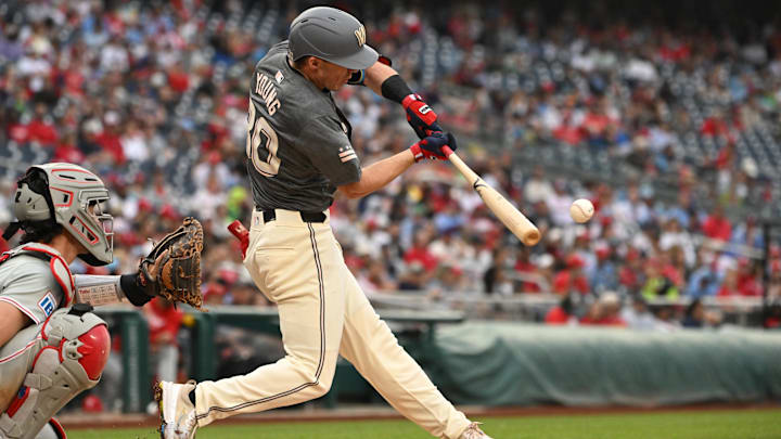 Sep 29, 2024; Washington, District of Columbia, USA; Washington Nationals center fielder Jacob Young (30) hits the ball into play against the Philadelphia Phillies during the fifth inning at Nationals Park